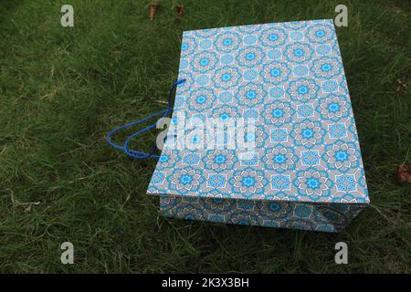 Colorful Paper Shopping bags are isolated on a green natural background. no plastic bags only eco-friendly bags. Stock Photo