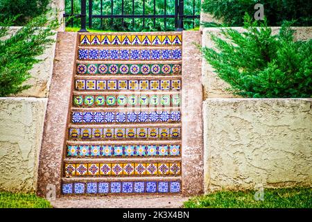 Beautiful colorful tuscan Mexican tile outdoor steps surrounded by stucco walls and landscapting Stock Photo