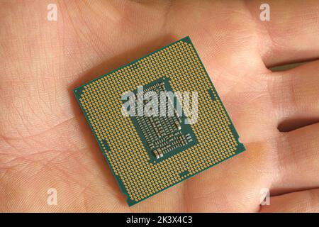 Man hold an hi tech desktop pc cpu part,computer components chip shortage Stock Photo