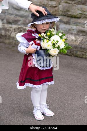 Swansea, Wales, UK. 27 September, 2022.   Two-year-old Charlotte Bunting waits to present a posy of flowers to the Duchess of Cambridge at St Thomas C