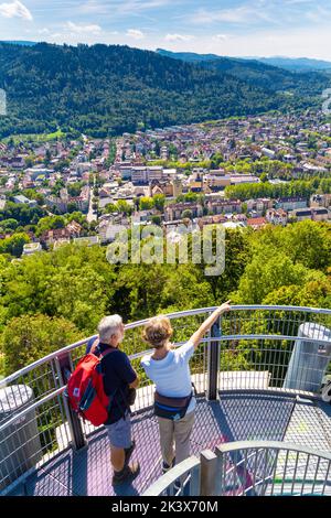 Man and woman enjoying views from the top of Castle Hill Tower (Aussichtsturm Schlossberg) in Schlossberg, Freiburg in Breisgau, Germany Stock Photo