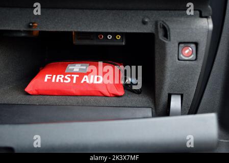 A first aid kit, in the glove box car. Useful in case of emergency after an accident. Stock Photo