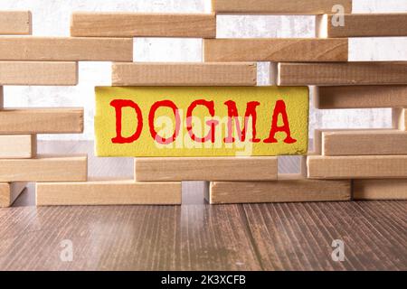 Wooden blocks with the text: dogma. Dogma word made with building blocks, business concept. Stock Photo