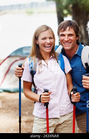 Couple ready to hike. Portrait of happy couple enjoying their vacation and getting ready for hiking. Stock Photo