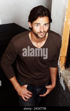 Rustic and rugged. Portrait of a handsome young man with his hands in his pockets. Stock Photo