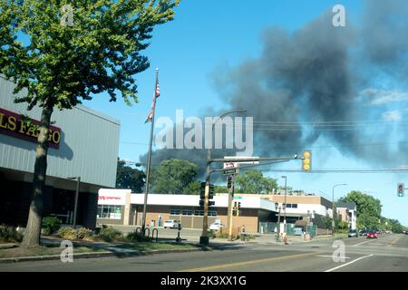 Sky filled with black smoke from a fire at a storage shed. St Paul Minnesota MN USA Stock Photo