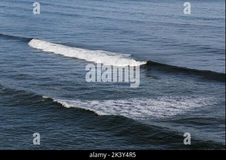 Waves surge and crest before reaching the shore. Stock Photo