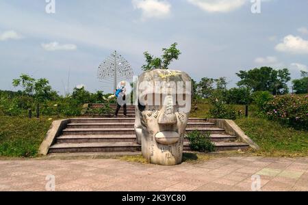A Woman walking around abandoned waterpark in Hue, Vietnam. Stock Photo