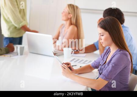 Typing out an email. A gorgeous young creative businesswoman working on her digital touchpad. Stock Photo
