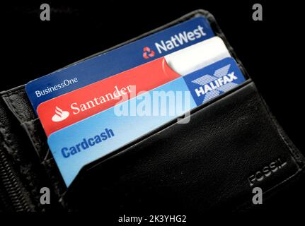 File photo dated 03/09/13 of a general view of a Halifax, Santander and NatWest bank cards in a wallet, as banks and building societies will have stronger incentives to prevent scams happening in the first place, as well as having to reimburse victims who have been tricked into transferring money to a fraudster, under a regulator's proposals. Stock Photo