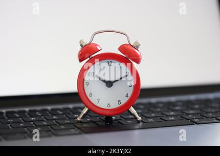 Red alarm clock for ten on laptop keyboard for business terms Stock Photo