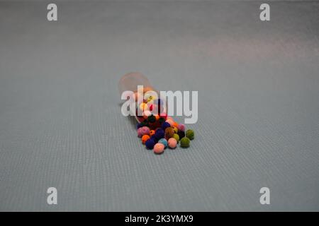 colorful beads in a traditional knitted bowl, on a black textured background Stock Photo