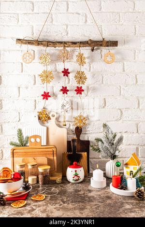 ceramic, wooden objects and decorations for the new year made of eco materials. vertical view of the part of the kitchen, decorated for the holiday Stock Photo