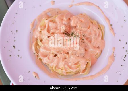 Pasta with shrimp and sour cream sauce with baked peppers. Stock Photo