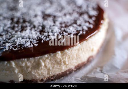 Close up of a Chocolate cake decorated with flaked coconut, homemade pie dessert, selective focus Stock Photo