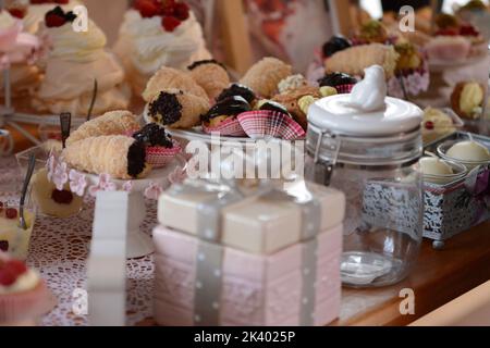 Rolls with crunchy chocolate and decorative jars around. Candy bar Stock Photo