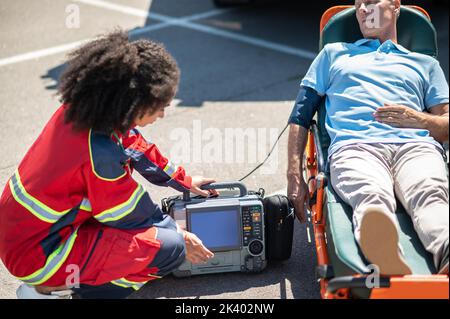 Doctor providing emergency care to an unconscious patient Stock Photo