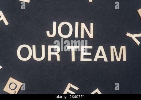 JOIN OUR TEAM word written on dark paper background. JOIN OUR TEAM text on dark for your designs, concept. Stock Photo