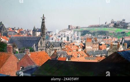 1987STEEPLEJACKS - Replacing an  unstable old  steeple with a shorter fiberglass replacement on the Catholic Church at the foot of Brunswick Street, in Whitby North Yorkshire. This view over the red  pantiled roofs of the town  also shows St Mary's Parish church and the old abbey. Stock Photo
