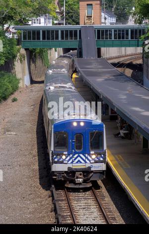 The Metro-North railroad train pulling into the Pleasantville station in Westchester on the way to Grand Central station in Manhattan. Stock Photo