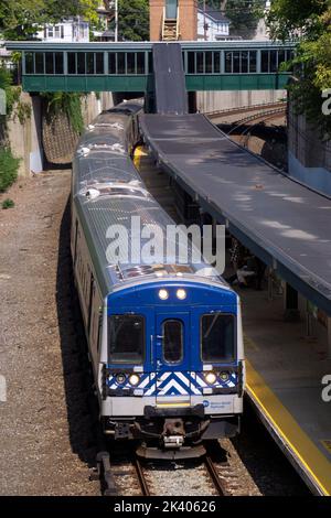 The Metro-North railroad train pulling into the Pleasantville station in Westchester on the way to Grand Central station in Manhattan. Stock Photo