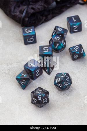 Dungeons and Dragons, a game of dice and imagination. Dice on grey with copy space Stock Photo