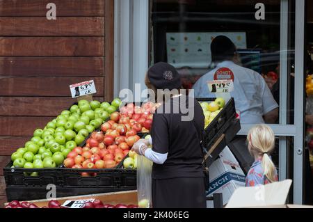 An unidentified orthodox Jewish woman buys apples the day before Rosh Hashanna, the Jewish New Year. In Williamsburg, Brooklyn, New York. Stock Photo