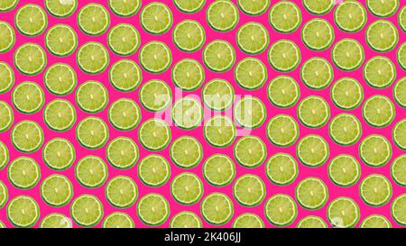 Colorful pattern of ripe lime slices on a pink background Stock Photo