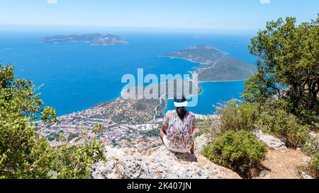 Kas turkey Asian women hiking up the mountain looking out over the ocean, Panoramic view from the mountain over the Kas Rivera, hiking up Lycian trail mountain of Kas Turkey.  Stock Photo