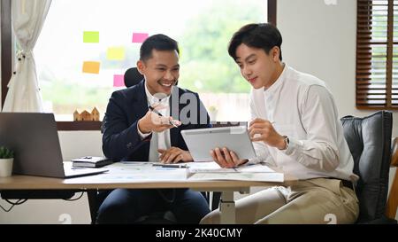 Professional Asian businessman or male boss working and meeting with his male assistant in the office. Stock Photo