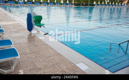 Swigging Pool Swinging arm disabled chair. Swimming pool lift with a chair Stock ...
