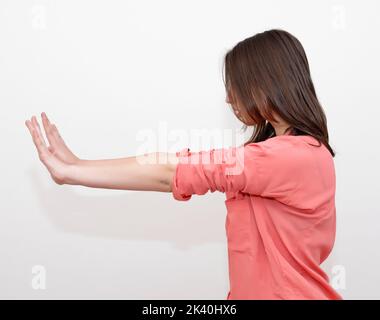 Woman pushing something imaginary - isolated over a white background stock photo Stock Photo