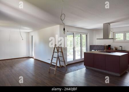 Painting walls and ceilings during painting work in the eat-in kitchen during interior design during house construction Stock Photo