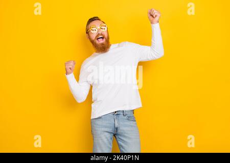 Photo of success beard orange hair man yell wear eyewear white shirt jeans isolated on yellow color background Stock Photo