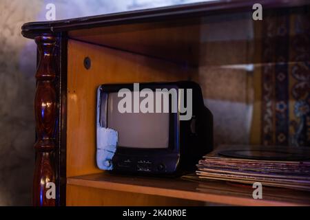 retro tv with wooden case in room with vintage wallpaper and parquet Stock Photo