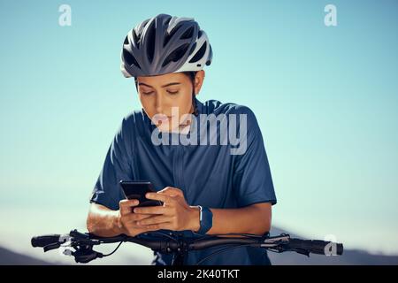 Woman on bicycle, search gps on smartphone with outdoor 5g internet and mobile application. Young bike cyclist checking location online on modern Stock Photo
