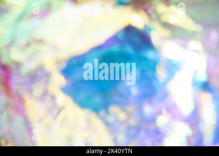 Unfocused holographic colors of mother-of-pearl foil. Crumpled iridescent foil with a real texture. Holographic iridescent abstract background. High quality photo Stock Photo