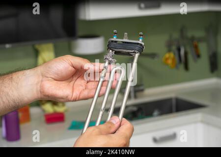 limescale and deposits on the heating element of a washing machine. Stock Photo