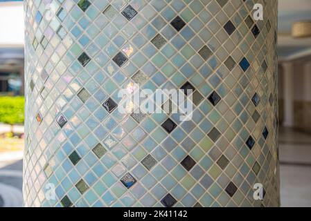 Concrete post lined with mosaic ceramic tiles Stock Photo