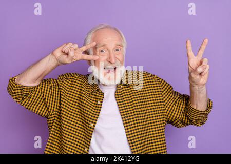 Photo of modern funky grandparent white hair make double v-sign dressed trendy yellow plaid shirt isolated on lilac purple color background Stock Photo