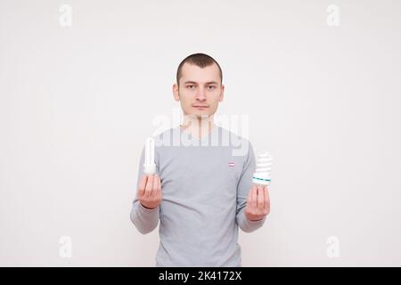 Man holding fluorescent light bulb in hand stock photo Stock Photo