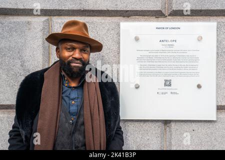 London UK. 29 September 2022  . Malawi born artist Samson Kambalu  poses  next to the plaque today  which commemorates the  sculptural piece, Antelope  unveiled  on the fourth plinth  in Trafalgar Square that depicts a 1914 photograph of European missionary John Chorley and Malawian Baptist preacher John Chilembwe, who fought against colonial rule. Credit: amer ghazzal/Alamy Live News. Stock Photo