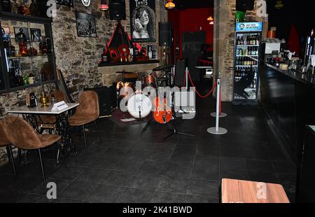 A bar stage ready for live music with a Gretsch guitar and drums, and a Fender amplifier. Santiago, Spain. Sept 24, 2022. Stock Photo