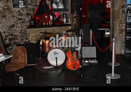 A bar stage ready for live music with a Gretsch guitar and drums, and a Fender amplifier. Santiago, Spain. Sept 24, 2022. Stock Photo