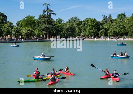 Spain, Madrid. Kayakers on El Retiro Lake, by Monument to Alfonso XII, El Retiro Park. Stock Photo