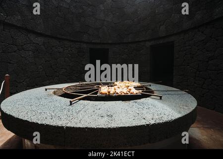 Tasty meat barbecued on volcanic heat, Timanfaya National Park, Canary Islands, Spain Stock Photo