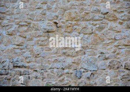 Rustic stone wall plastered on it Stock Photo