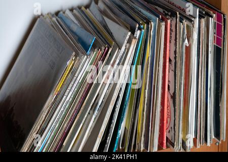 Stack of old vinyl LP records on shelf Stock Photo