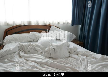 white color messy bed in early morning , messy bed after waking up  Stock Photo