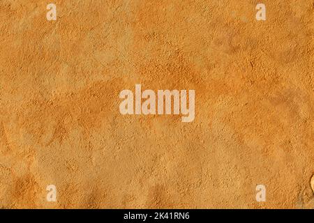 Orange colored plastered wall Stock Photo